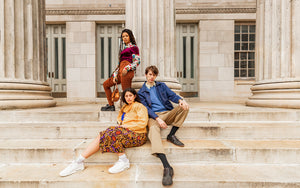 Three people wearing vintage from the 1940’s to 1990’s on steps in downtown Brooklyn New York